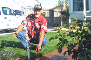 a Highland Village sprinkler repair specialist is repairing a bad sprinkler head