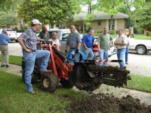 The sprinkler installation team lets the trencher rest during an install