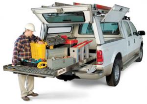 a Highland Village irrigation repair specialist is unloading the tools from his truck