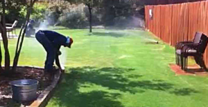 an Irrigation specialist adjusts a pop up head